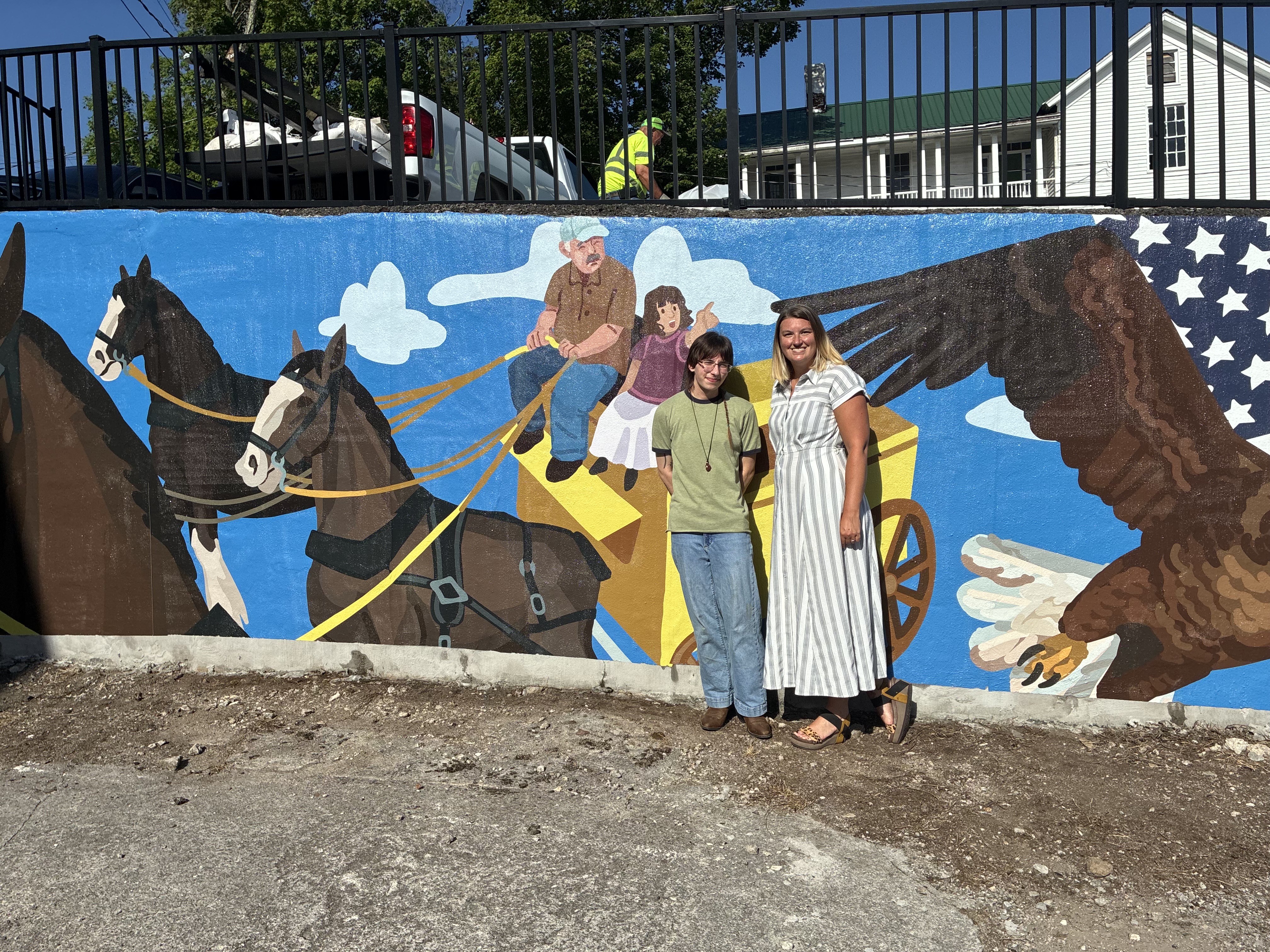Alan Tuhacek and Morgan Gilbert in front of the Mural