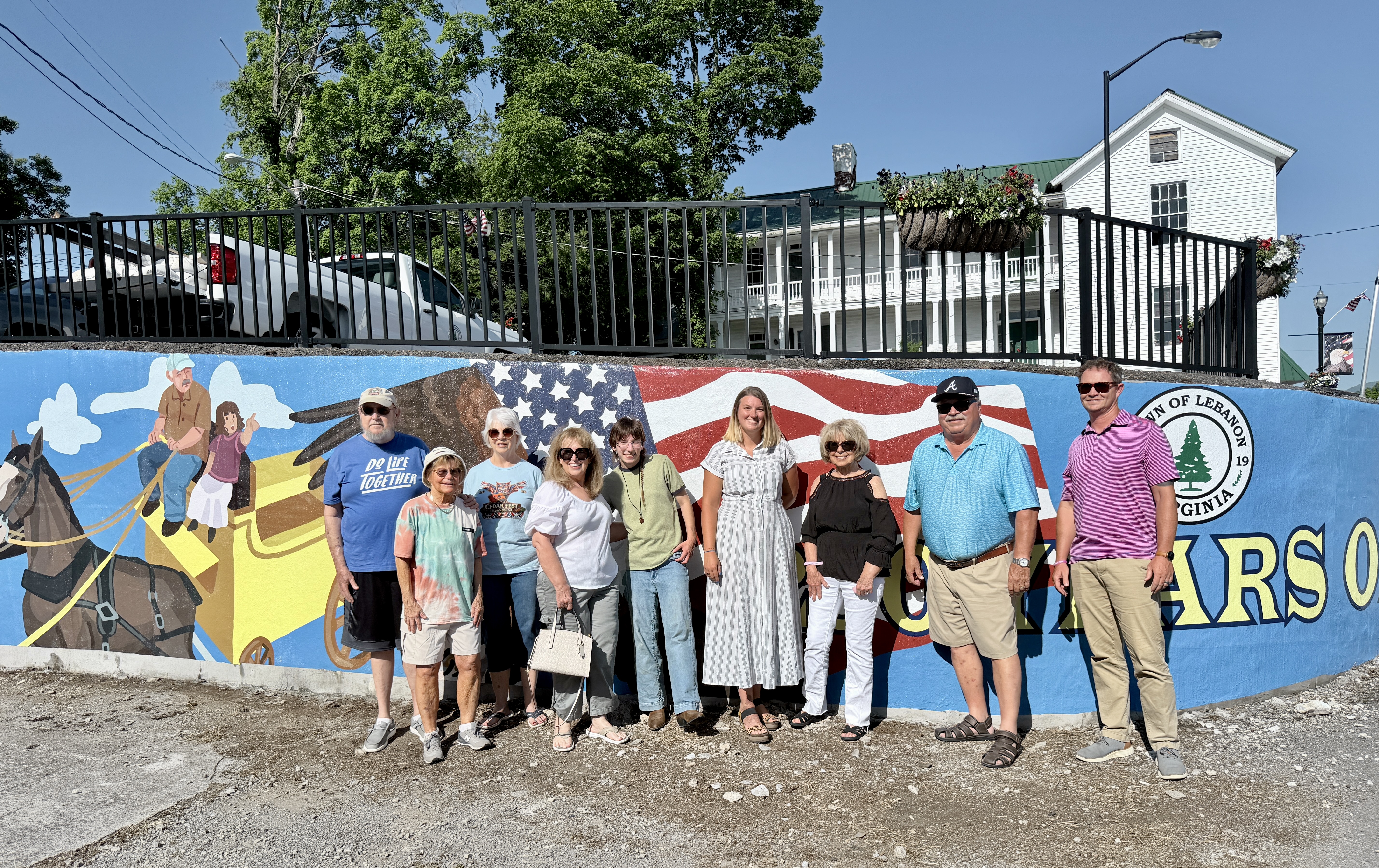 Group of people standing in front of new Mural