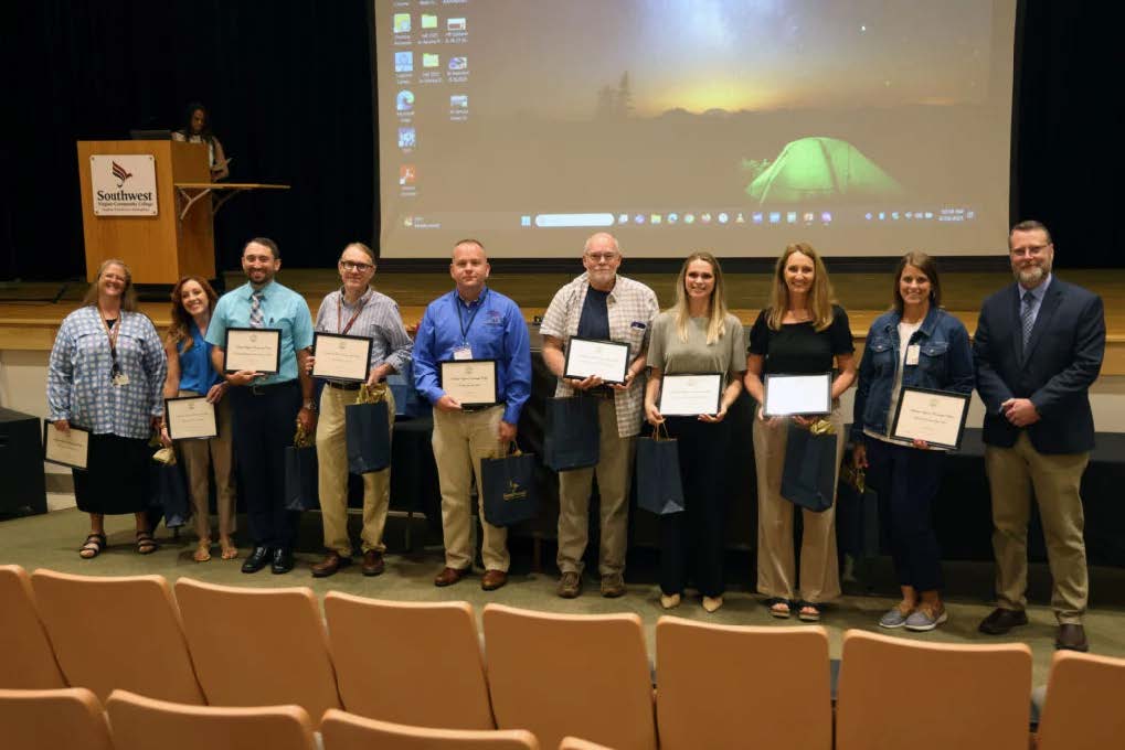 a group of Southwest Faculty and Staff being recognized for their hard work with Dr. Hayes.