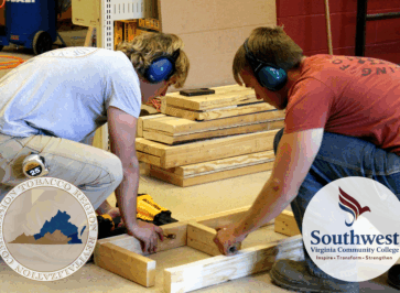 Two students working on a carpentry class project. Overlaid on the photo are two logos, one for Southwest Virginia Community College, and the other for the Virginia Tobacco Region Revitalization Commission.