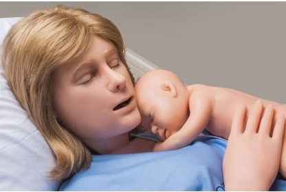 Medical training mannequin lying in a hospital bed wearing a blue patient gown, with eyes closed and mouth slightly open. A newborn training mannequin rests on the adult mannequin’s chest with head turned to the side and body curled inward, suggesting immediate post-delivery positioning in a clinical simulation environment.