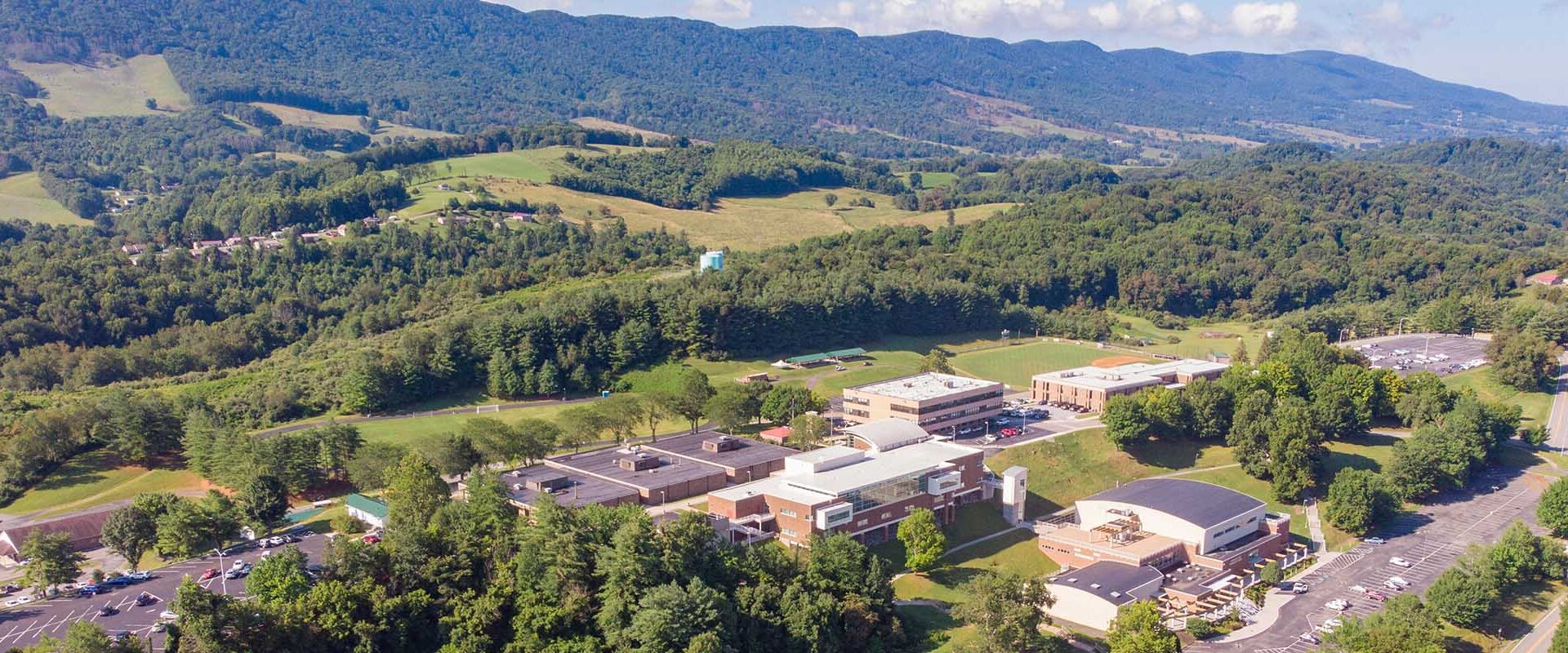 Aerial view of Southwest Virginia Community College surrounded by trees and rolling mountain terrain.