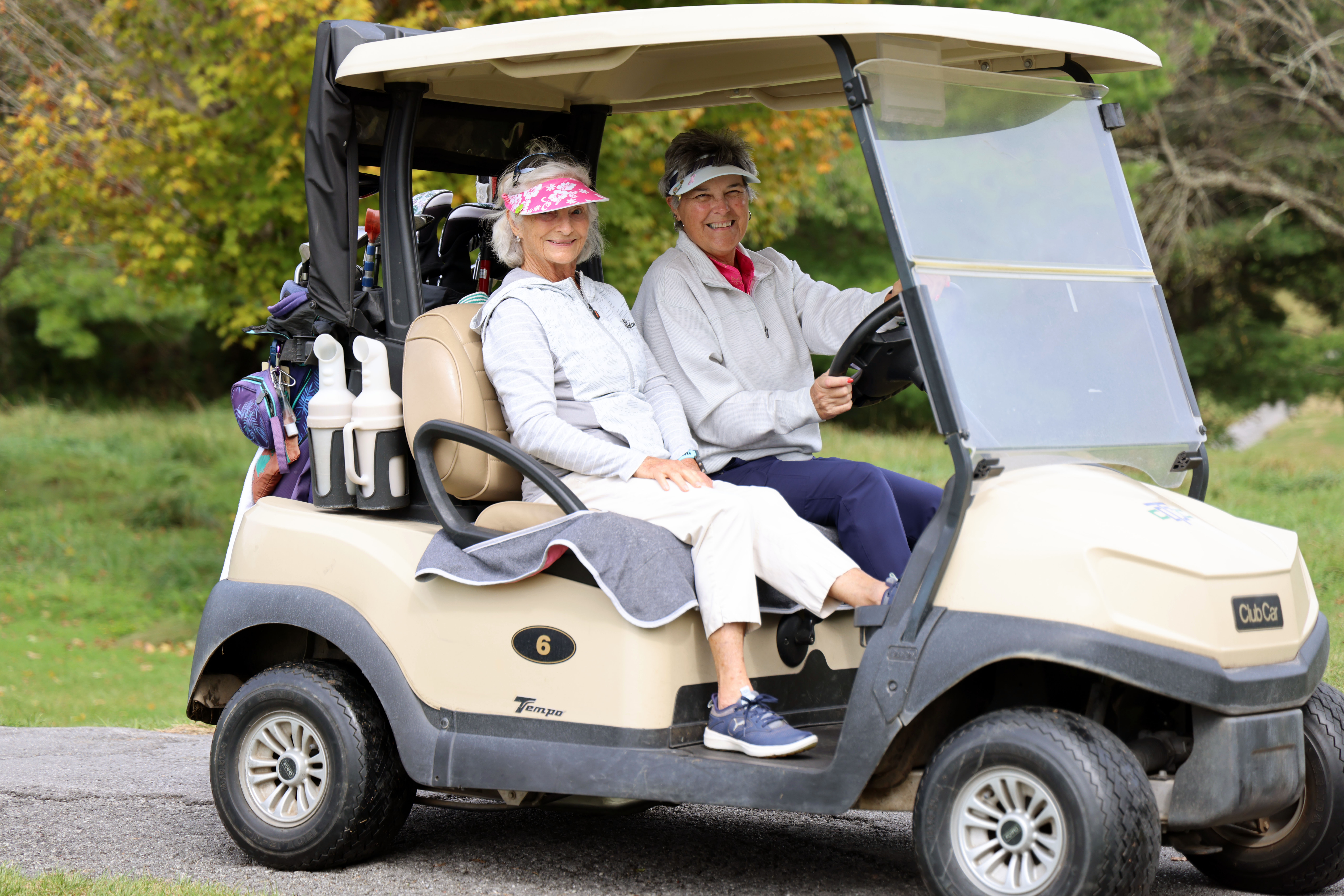 Two women on a golf kart